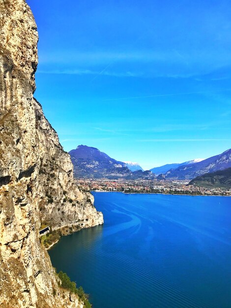 Scenic view of sea and rocks against blue sky