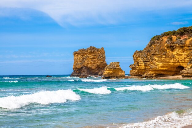 Scenic view of sea and rocks against blue sky