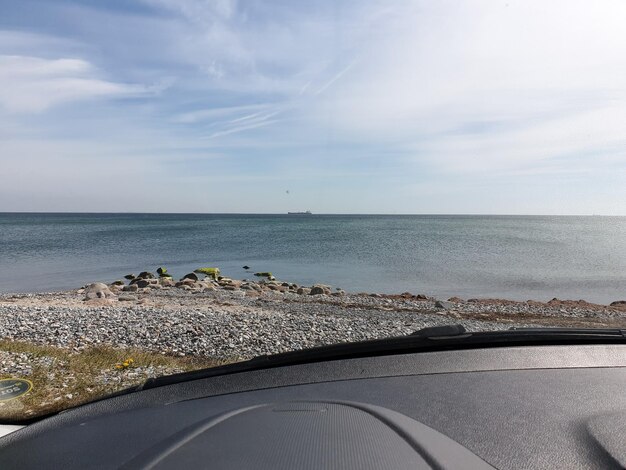 Scenic view of sea seen through car windshield