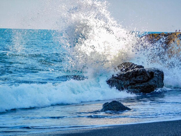 Scenic view of sea waves splashing on rocks