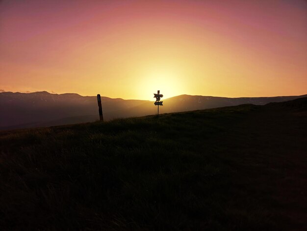 Scenic view of silhouette field against sky during sunset