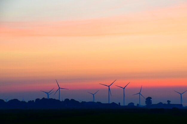 Scenic view of silhouette field against sky during sunset