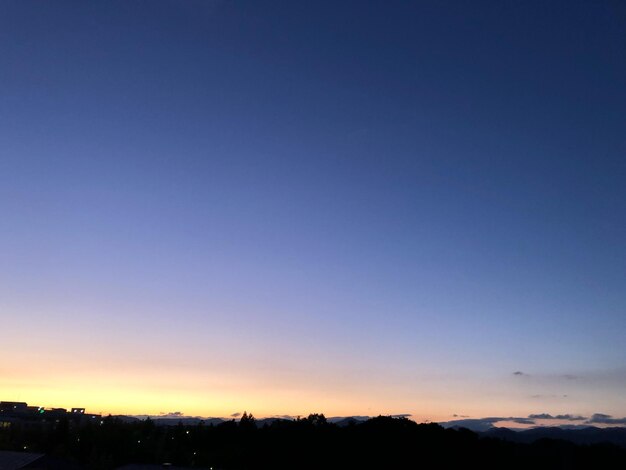 Scenic view of silhouette landscape against clear sky at sunset