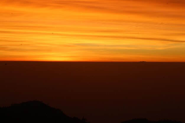 Scenic view of silhouette landscape against romantic sky at sunset