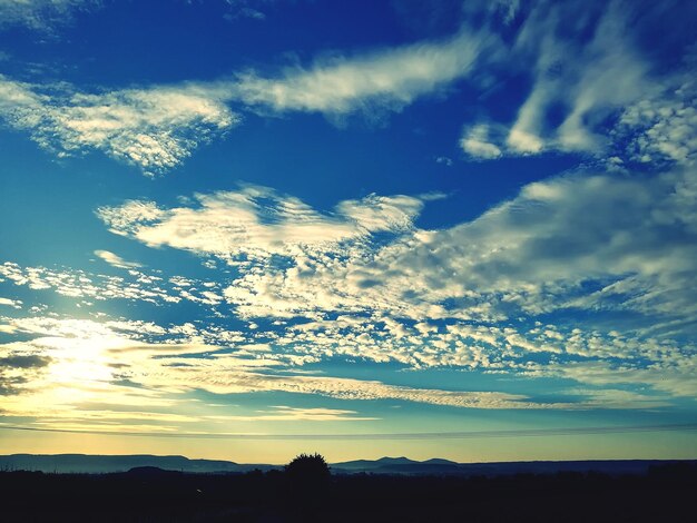 Scenic view of silhouette landscape against sky at sunset