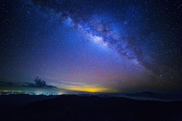 Scenic view of silhouette mountain against star field at night