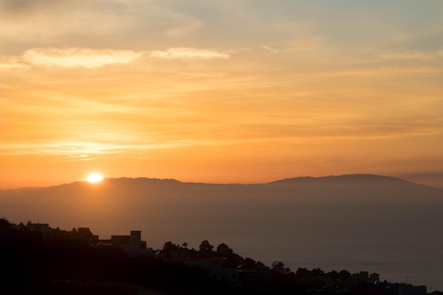 Scenic view of silhouette mountains against romantic sky at sunset