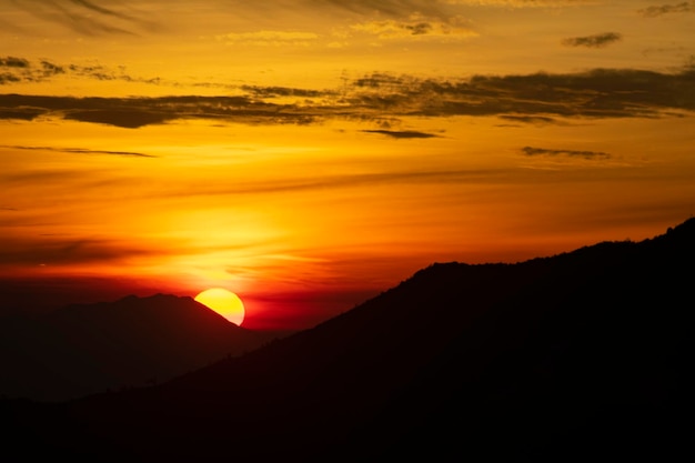 Scenic view of silhouette mountains against romantic sky at sunset