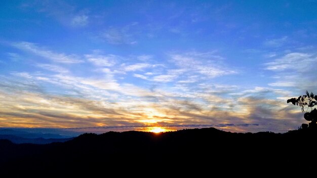 Scenic view of silhouette mountains against sky during sunset