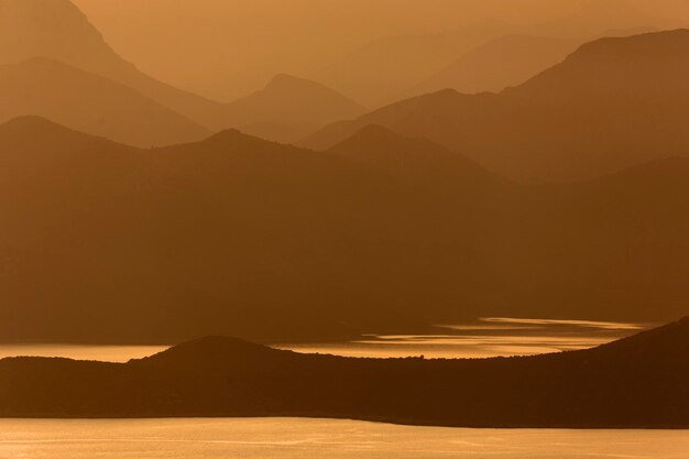 Scenic view of silhouette mountains against sky during sunset