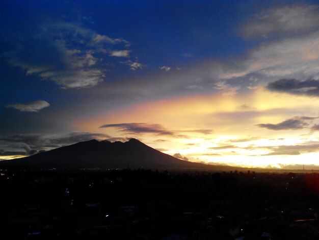 Scenic view of silhouette mountains against sky during sunset