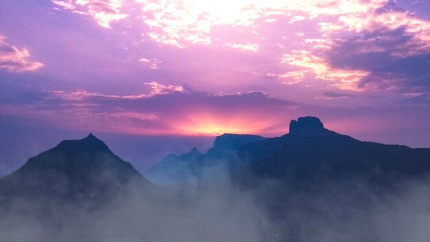 Scenic view of silhouette mountains against sky at sunset