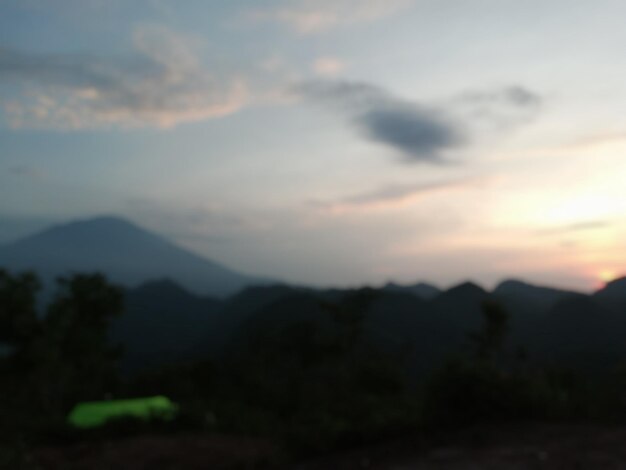 Scenic view of silhouette mountains against sky at sunset