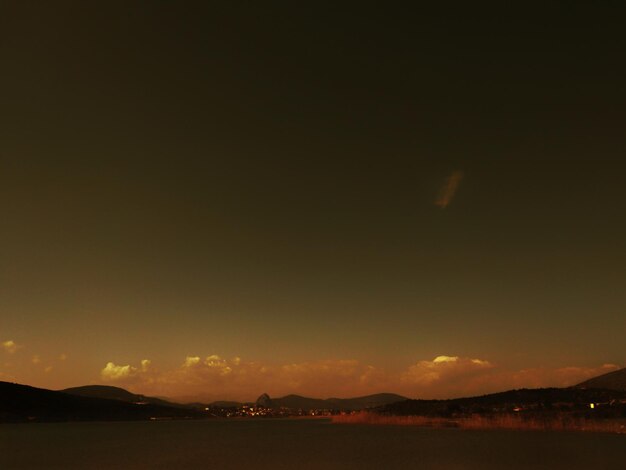 Scenic view of silhouette mountains against sky at sunset