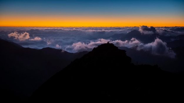 Scenic view of silhouette mountains against sky at sunset