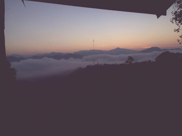 Scenic view of silhouette mountains against sky at sunset