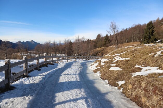 Scenic view of snow covered field against sky