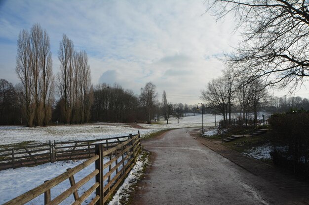 Scenic view of snow covered field against sky