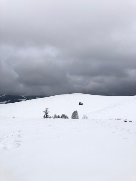 Scenic view of snow covered land against sky