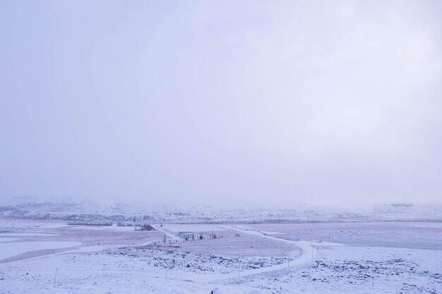 Scenic view of snow covered landscape against sky