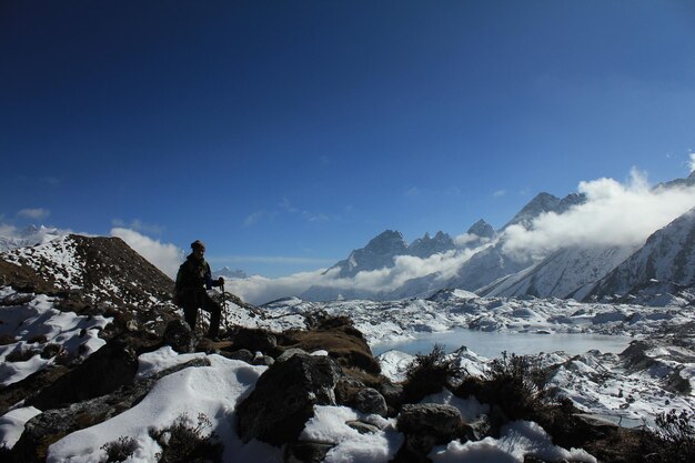 Scenic view of snow covered mountains against blue sky