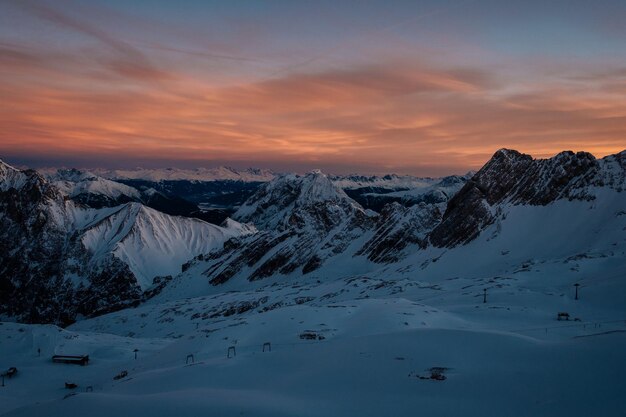 Scenic view of snow mountains against sky during sunset