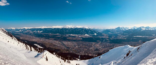 Scenic view of snowcapped mountains against blue sky