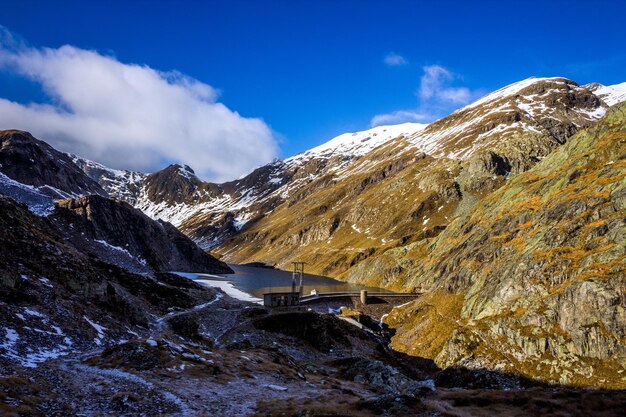 Scenic view of snowcapped mountains against blue sky