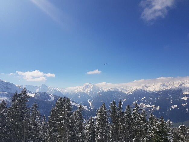 Scenic view of snowcapped mountains against blue sky