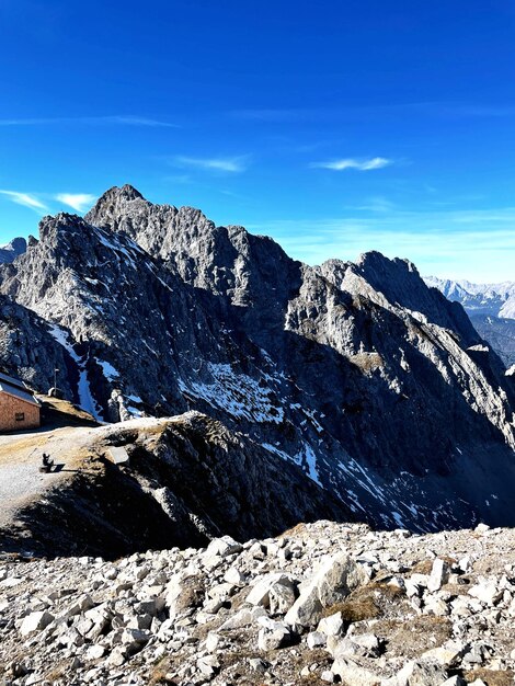 Scenic view of snowcapped mountains against blue sky