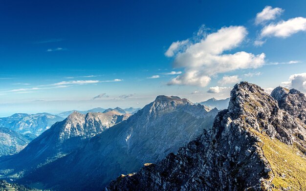 Scenic view of snowcapped mountains against blue sky