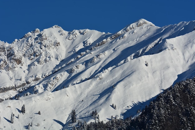 Scenic view of snowcapped mountains against blue sky