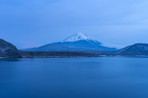 Scenic view of snowcapped mountains against blue sky