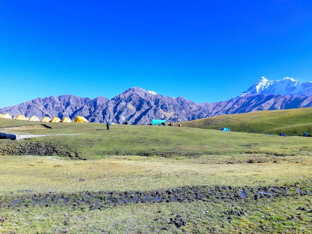 Scenic view of snowcapped mountains against blue sky