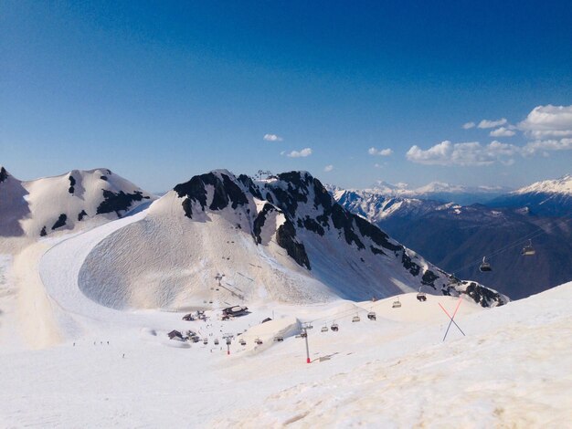 Scenic view of snowcapped mountains against blue sky