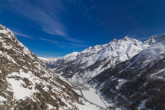 Scenic view of snowcapped mountains against blue sky