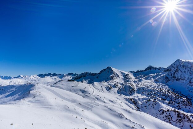 Scenic view of snowcapped mountains against blue sky