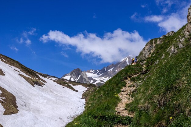 Scenic view of snowcapped mountains against blue sky