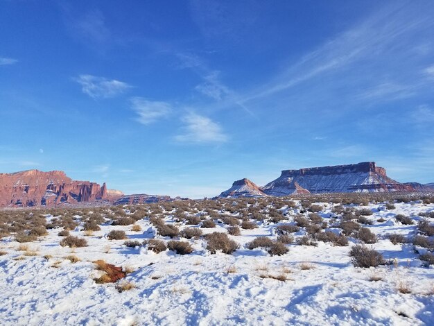 Scenic view of snowcapped mountains against blue sky