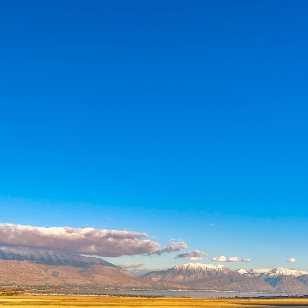 Scenic view of snowcapped mountains against blue sky