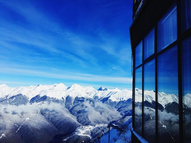 Scenic view of snowcapped mountains against blue sky