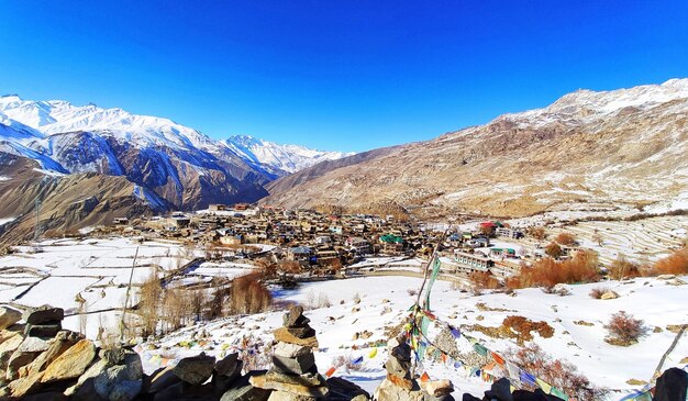 Scenic view of snowcapped mountains against blue sky