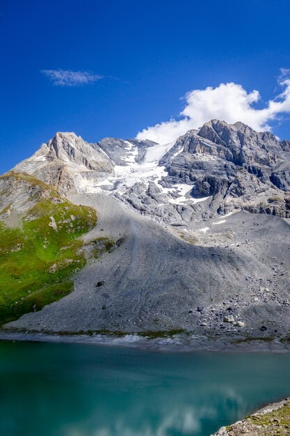 Scenic view of snowcapped mountains against blue sky