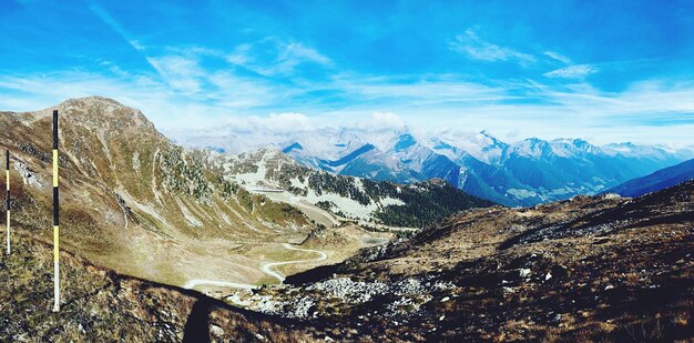 Scenic view of snowcapped mountains against blue sky