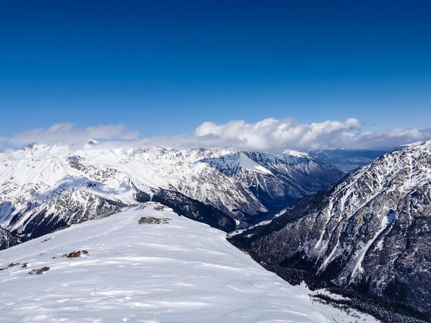 Scenic view of snowcapped mountains against blue sky