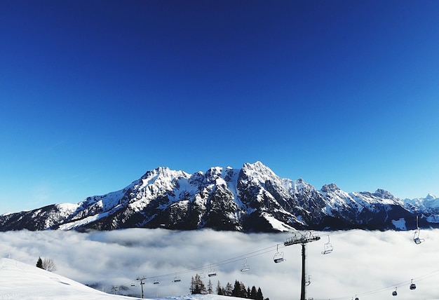 Scenic view of snowcapped mountains against clear blue sky