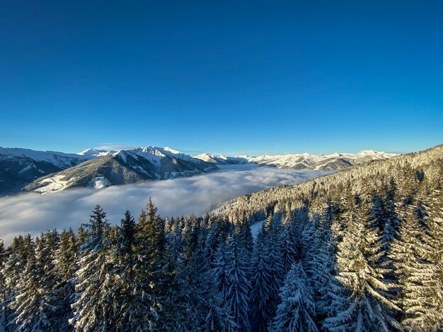 Scenic view of snowcapped mountains against clear blue sky