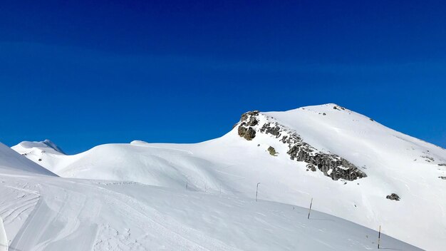 Scenic view of snowcapped mountains against clear blue sky