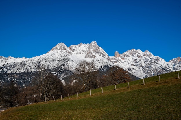 Scenic view of snowcapped mountains against clear blue sky