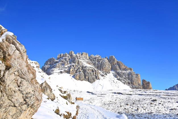 Scenic view of snowcapped mountains against clear blue sky